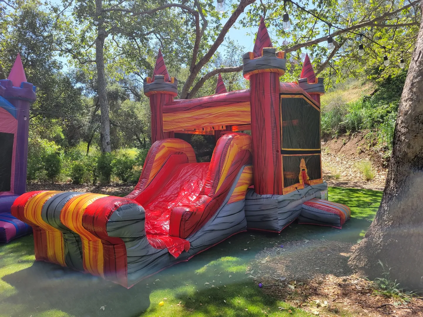 A red and yellow inflatable castle with slide.