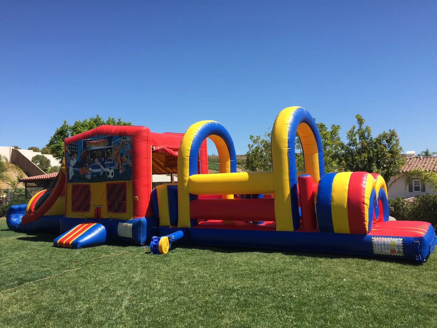 A large inflatable obstacle course set up in the grass.