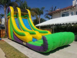 A large inflatable slide in the yard of a house.