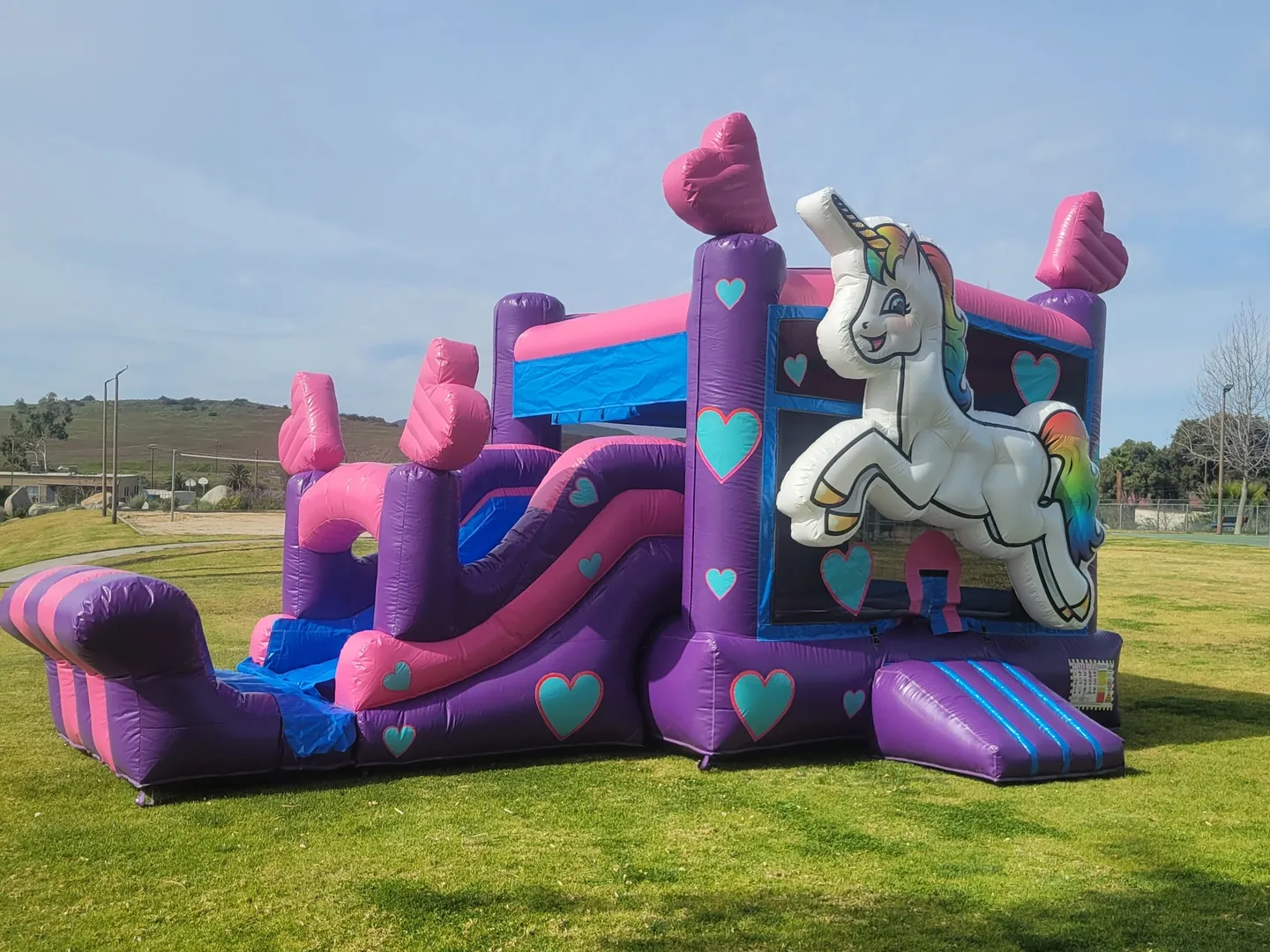 A large inflatable slide with a unicorn on it.