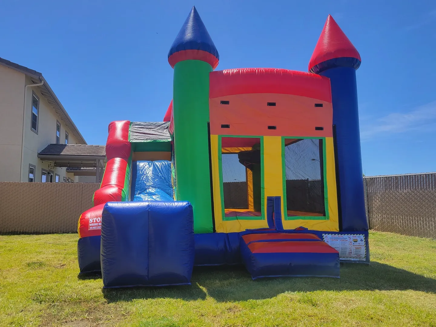 A bouncy house with a slide in the middle of it.