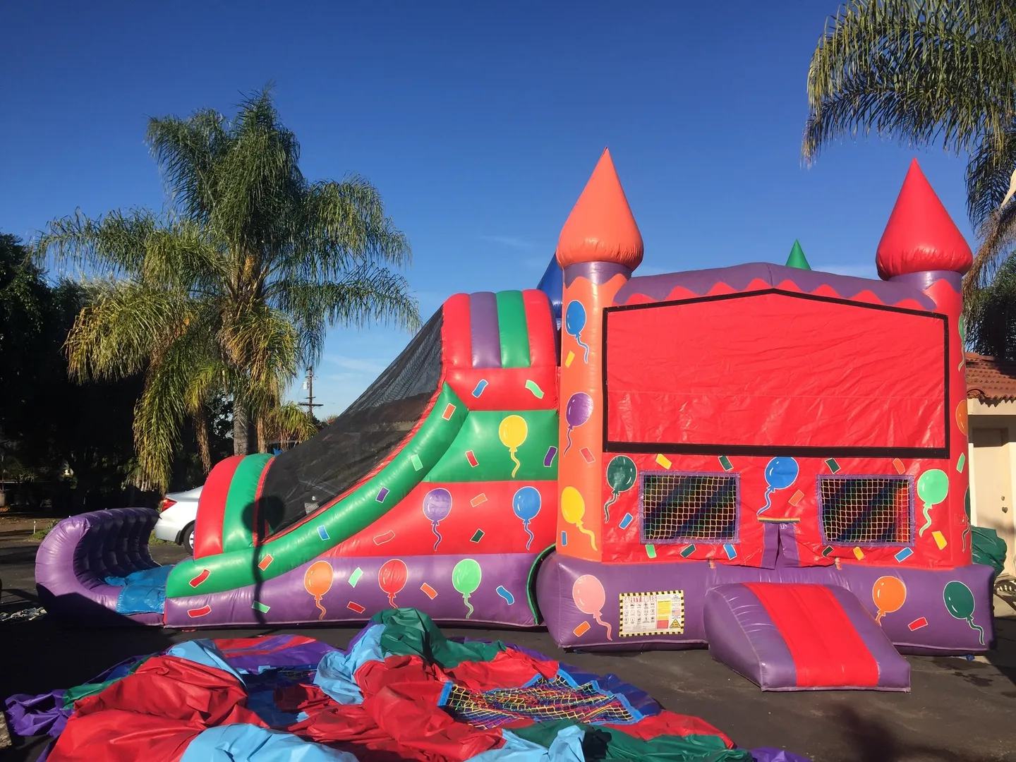 A large inflatable slide in the middle of a yard.