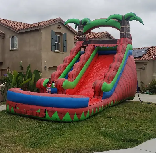A large inflatable slide in the yard of a house.