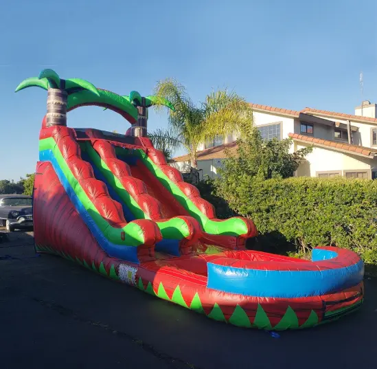 A large inflatable slide with palm trees on it.