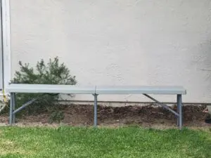 A bench in the grass near some bushes