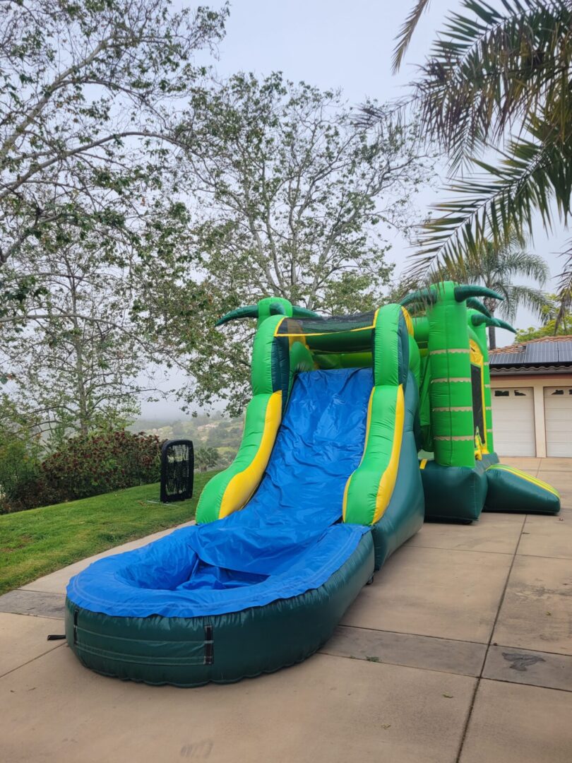 A large inflatable slide with palm trees on it.
