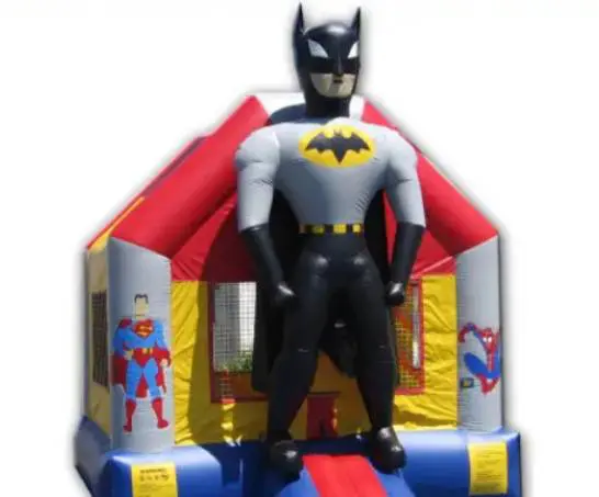 A batman inflatable bouncer with superman and superheros on it.