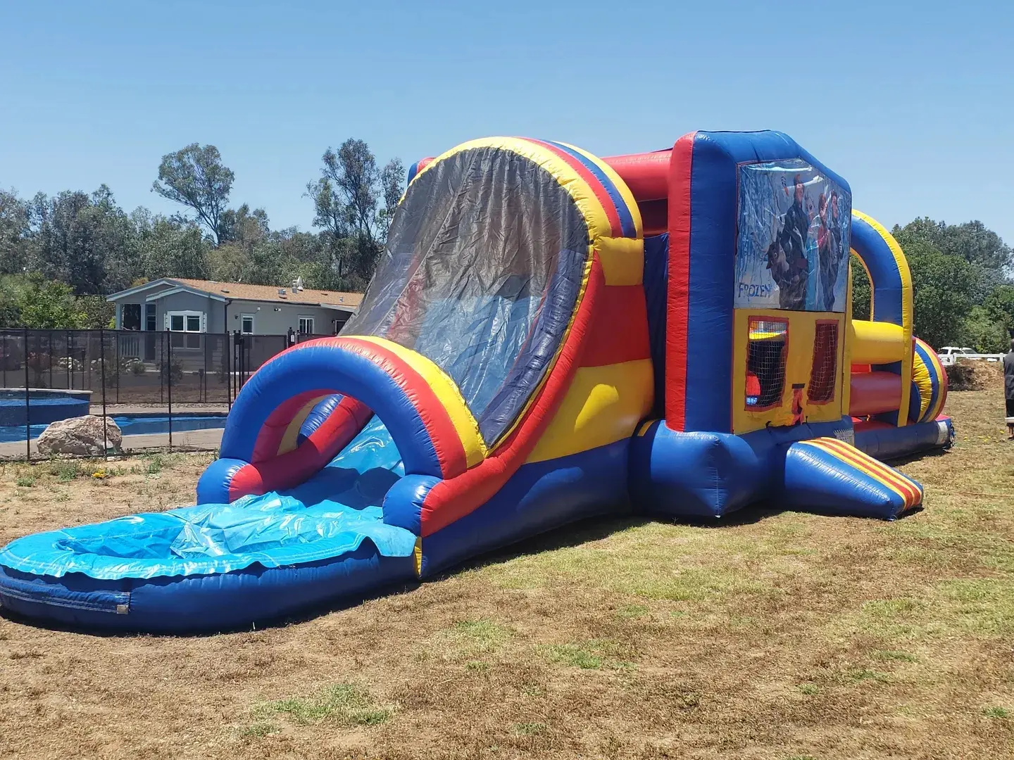 A large inflatable slide with water coming out of it.