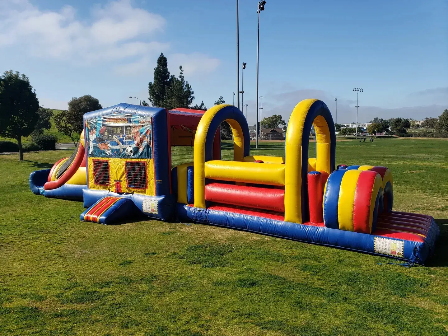 A large inflatable obstacle course set up in the grass.